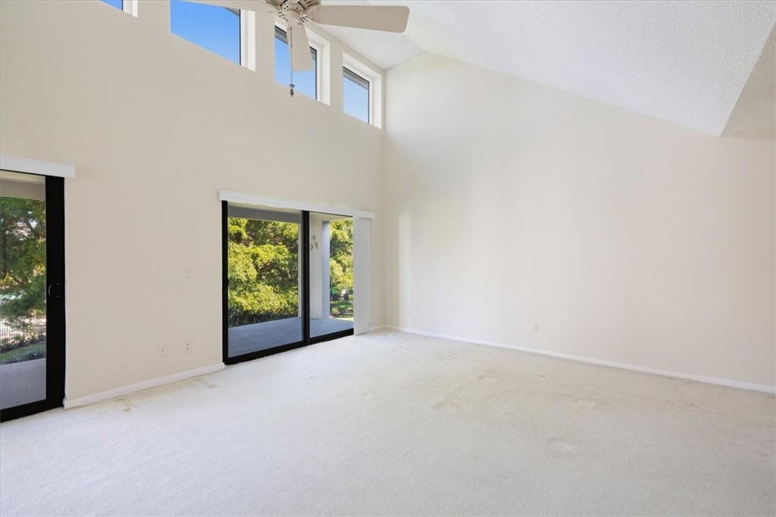 Vaulted ceiling, high transom windows, sliding glass doors, ceiling fan