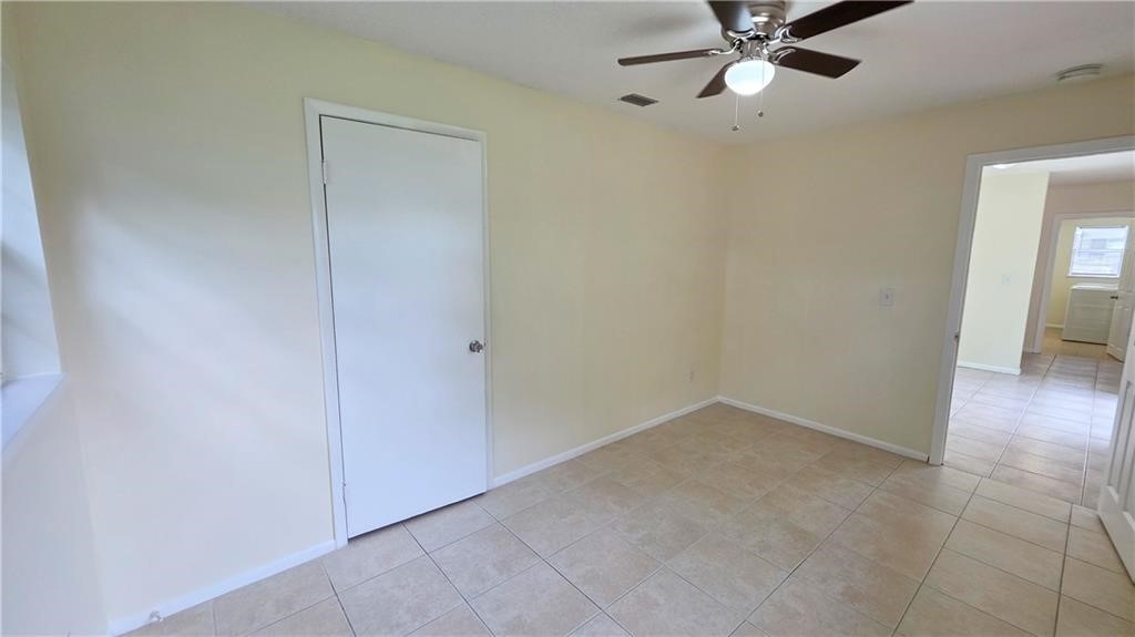 Recessed lighting with a ceiling fan, neutral wall tones, and tiled flooring