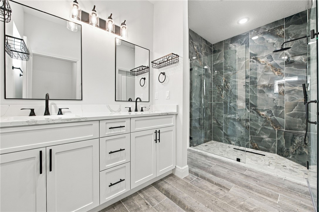 Dual vanity with white cabinetry and matte black hardware