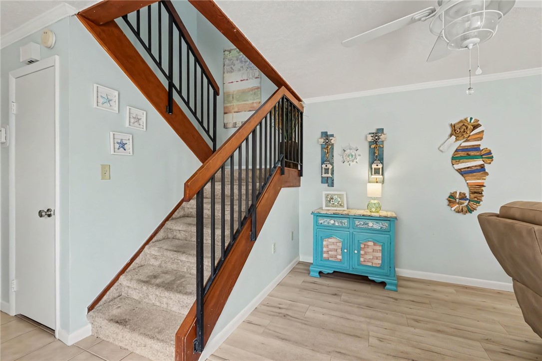 Staircase with wood railings and black balusters