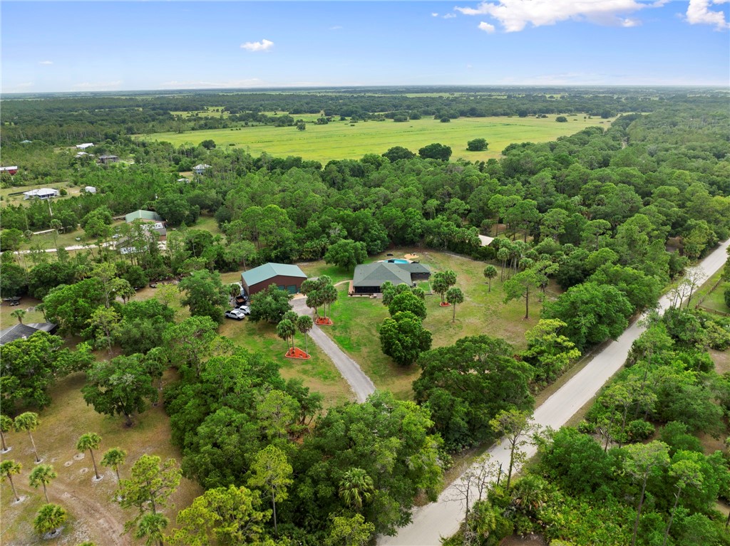 Expansive property with a main residence, additional structure, and a private swimming pool