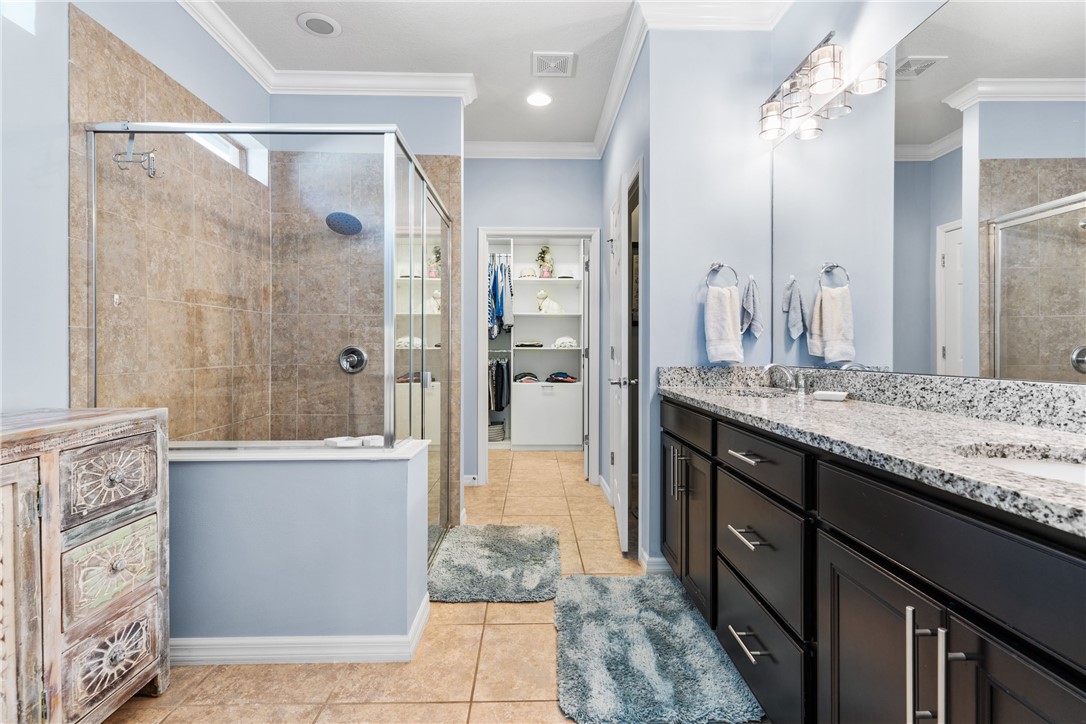 Dual vanity with dark wood cabinetry and stone countertop