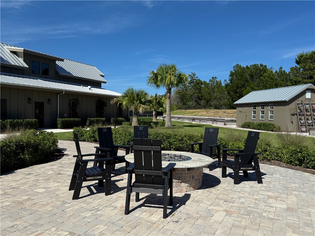 Paver patio featuring a stone-clad fire pit