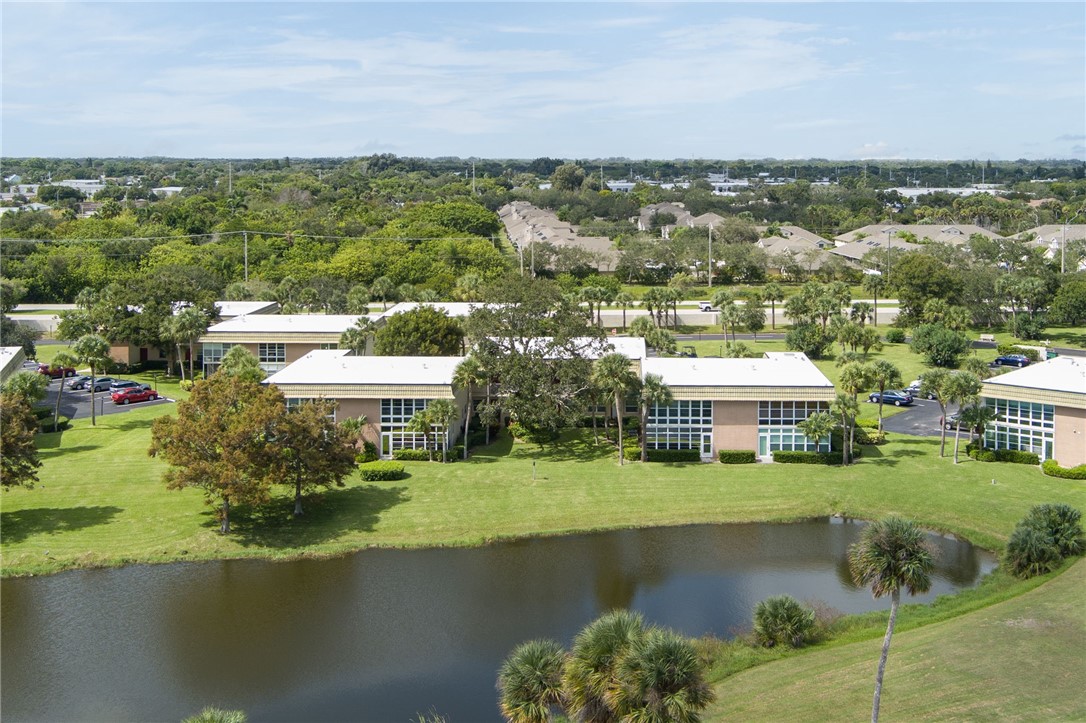 Aerial perspective showcasing multiple residential buildings with a waterscape