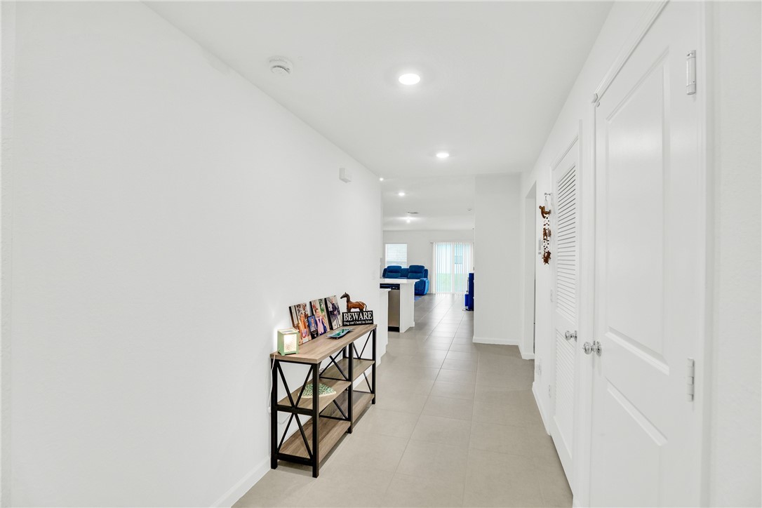 Recessed lighting, light-toned wall finishes, and tile flooring