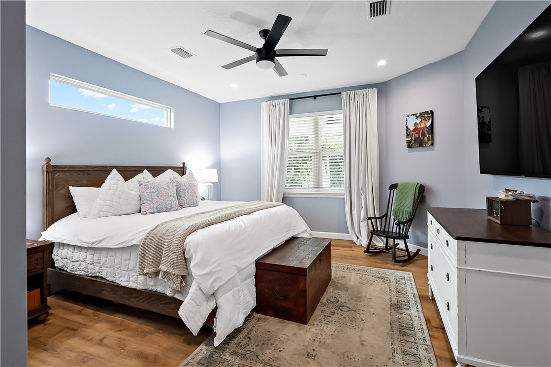 Wood-finish flooring with a rectangular area rug