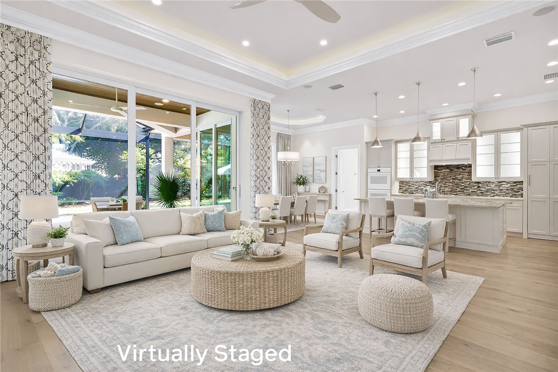 Living room with a ceiling fan, light wood-type flooring, ornamental molding, and recessed lighting