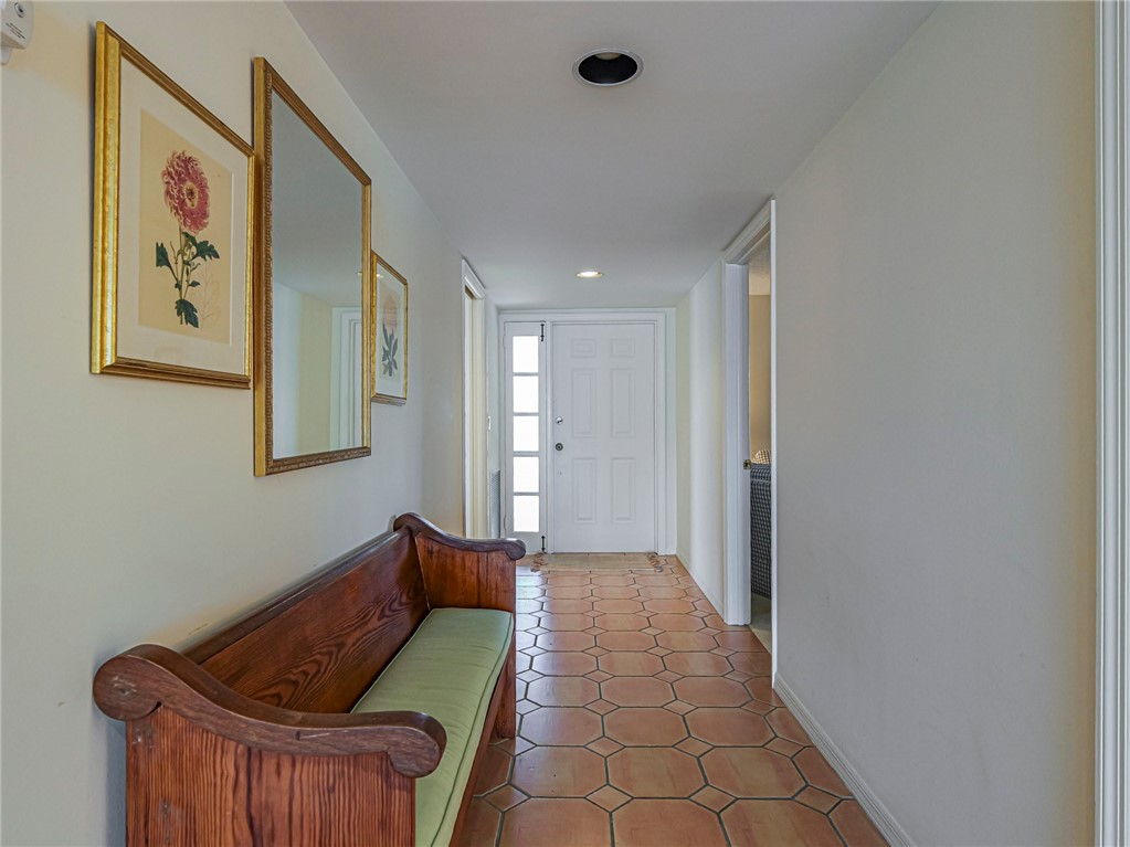 Front entry featuring a solid paneled door with sidelights, recessed lighting, and hexagonal tile flooring