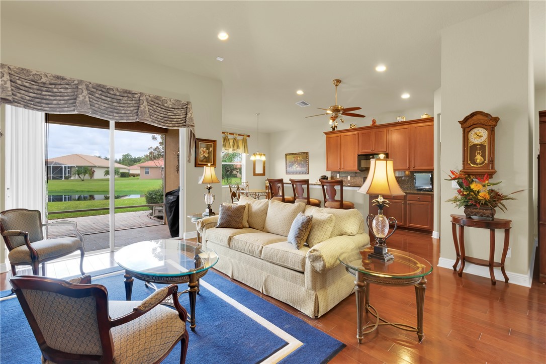 Hardwood-finish flooring, recessed lighting, sliding glass doors, built-in cabinetry, and a ceiling fan
