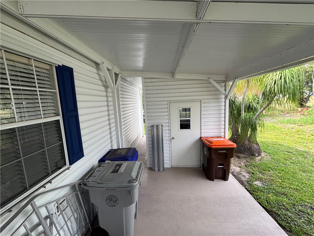 Covered exterior patio featuring a concrete surface