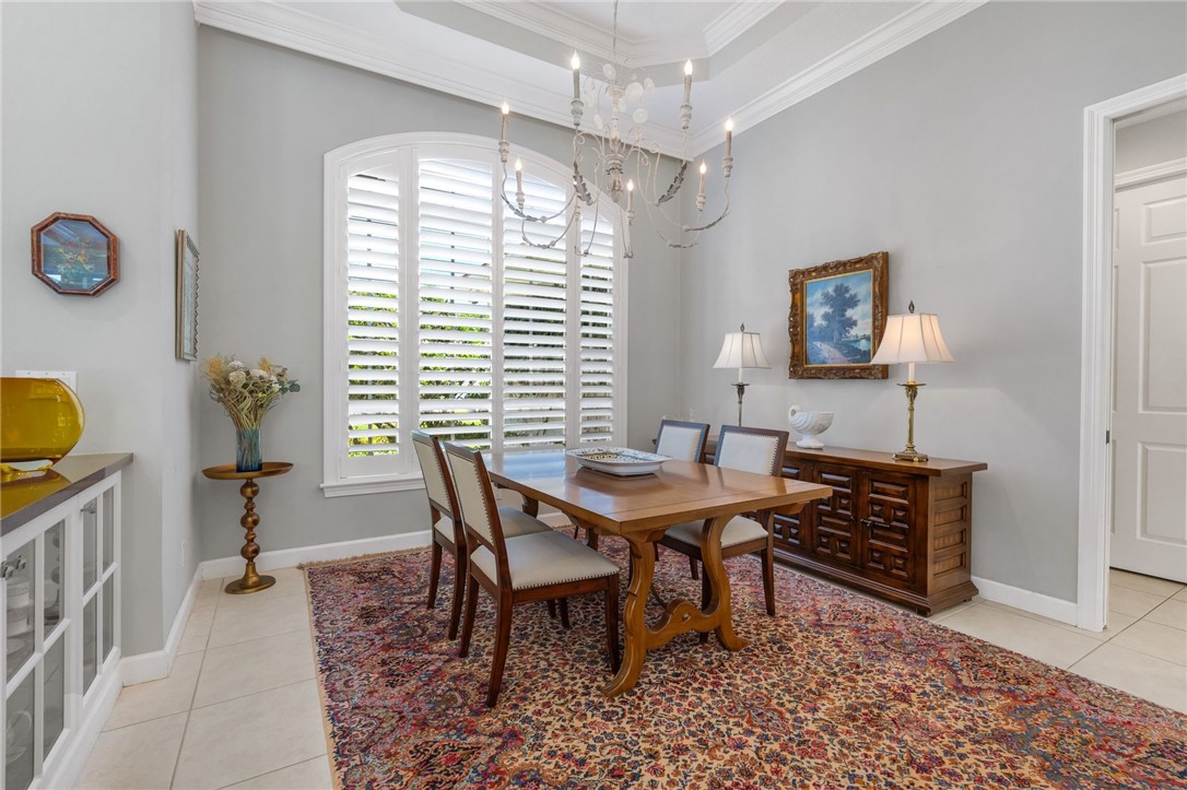Dining Room w/arched window, plantation shutters and built-in cabinetry