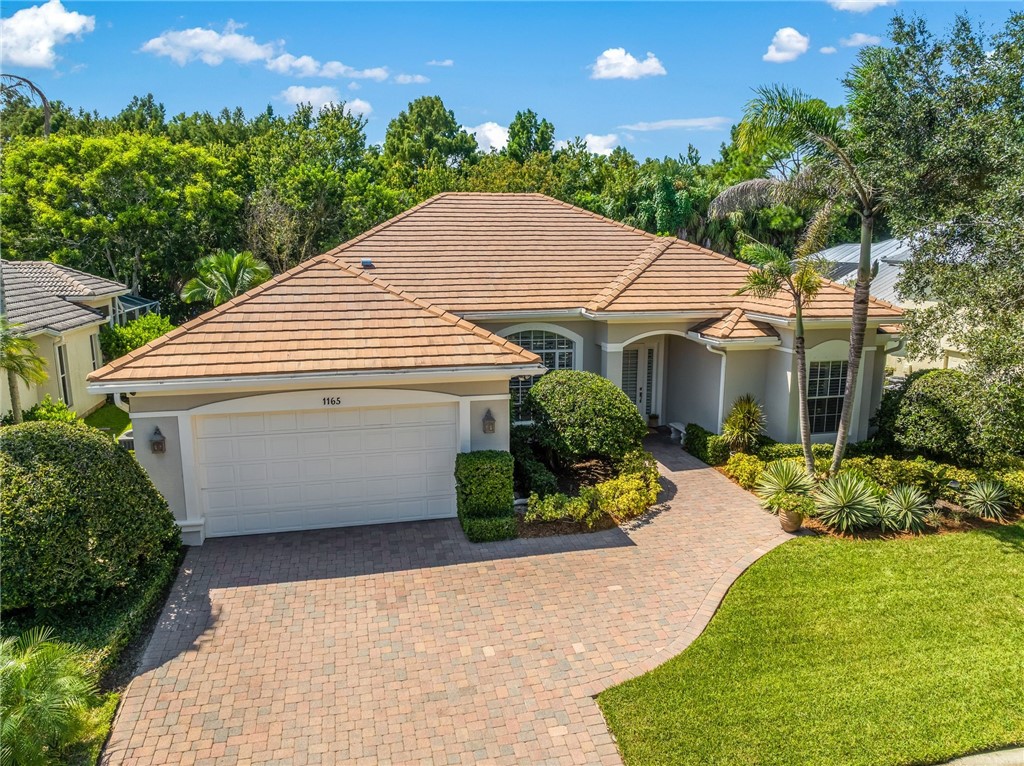 Exterior front with extended paver driveway, two car garage