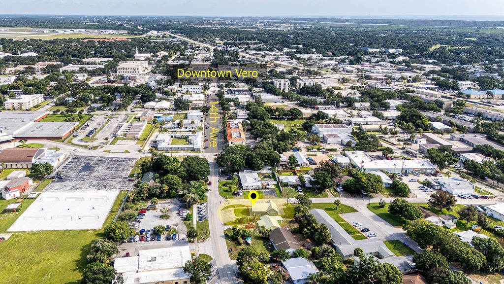 Aerial view of Downtown Vera showcasing a thriving commercial and residential corridor with mature tree canopy throughout the community
