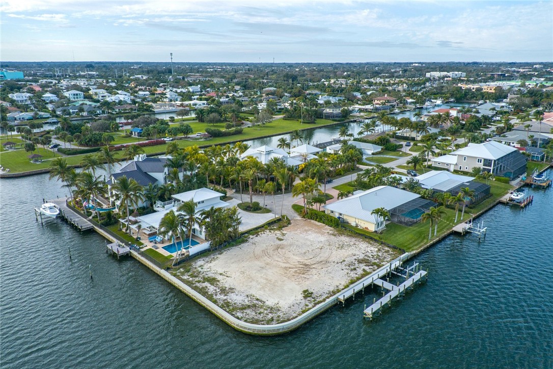 Aerial perspective of suburban area featuring a nearby body of water