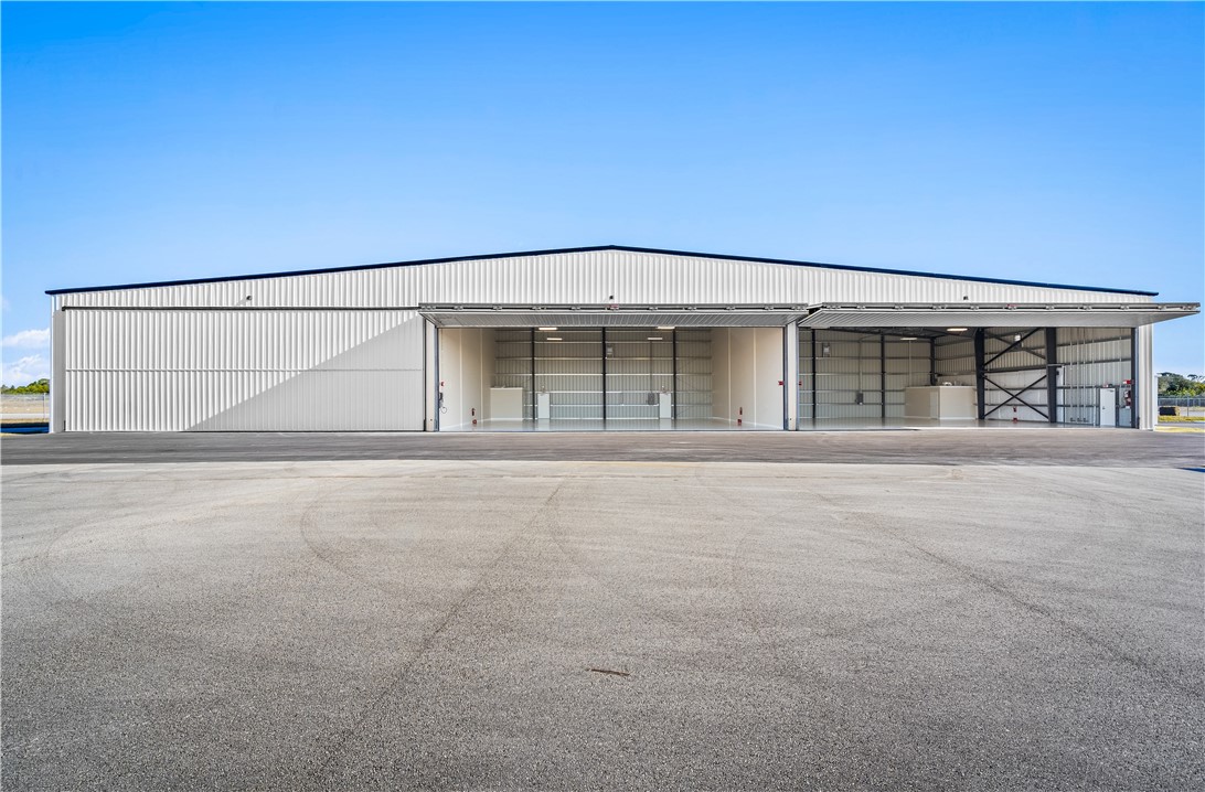 Industrial-style structure featuring a metal exterior and a black trim roofline