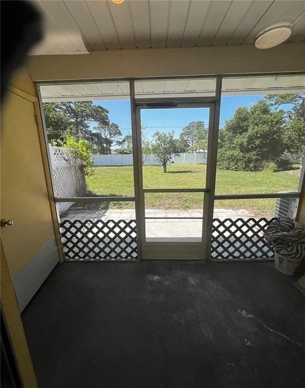 Screened enclosure with a lattice accent wall and a direct exterior access door
