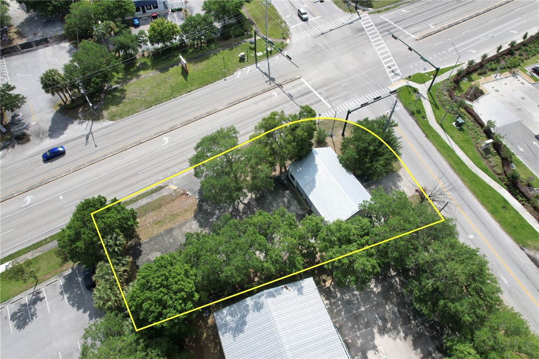 Aerial view of property and surrounding area with property parcel outlined