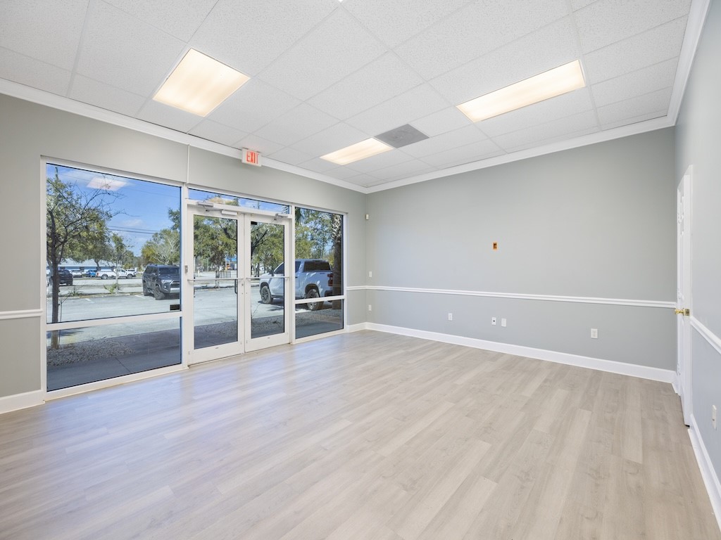 Spare room featuring a paneled ceiling, light wood finished floors, and french doors