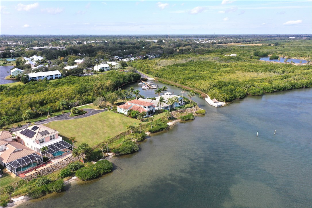 Aerial view of property and surrounding area with a large body of water