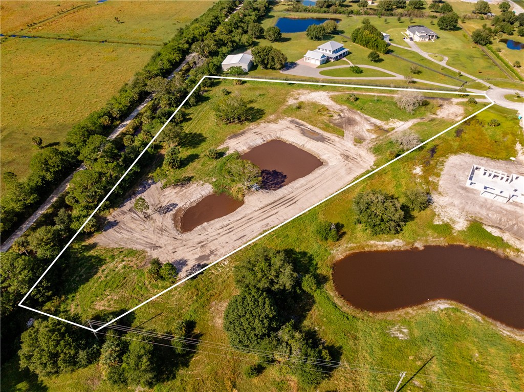 View of property location with a nearby body of water and property boundaries highlighted