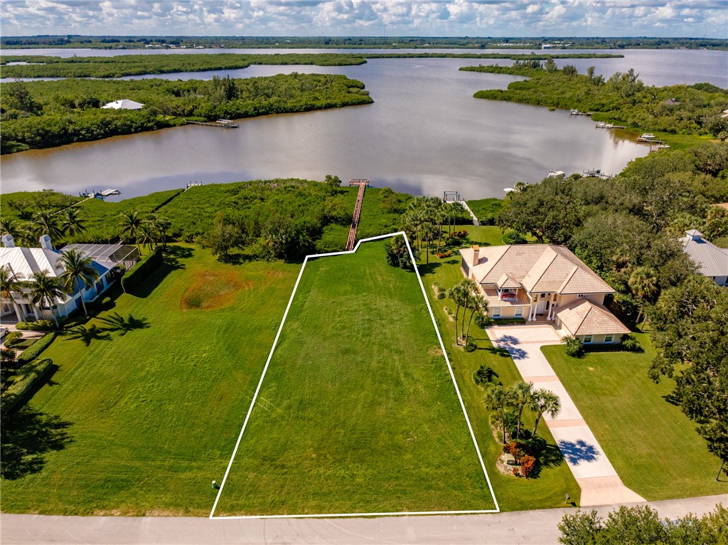 Aerial view of property's location featuring a large body of water and property parcel outlined