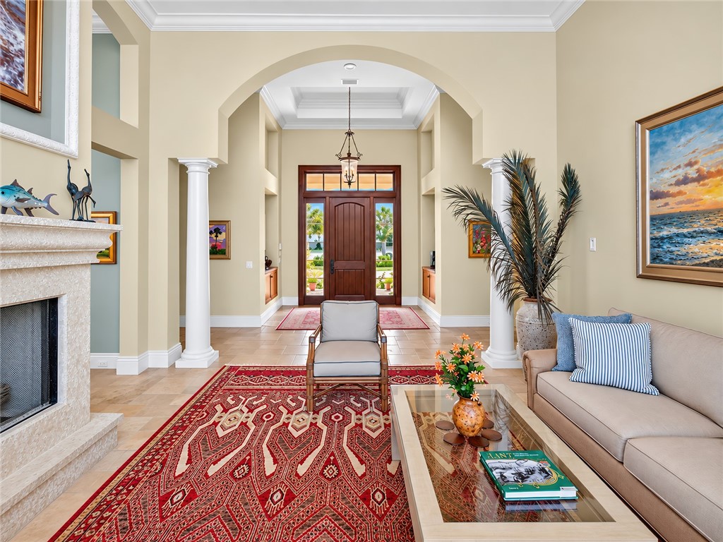 Grand foyer featuring a vaulted ceiling with recessed tray lighting