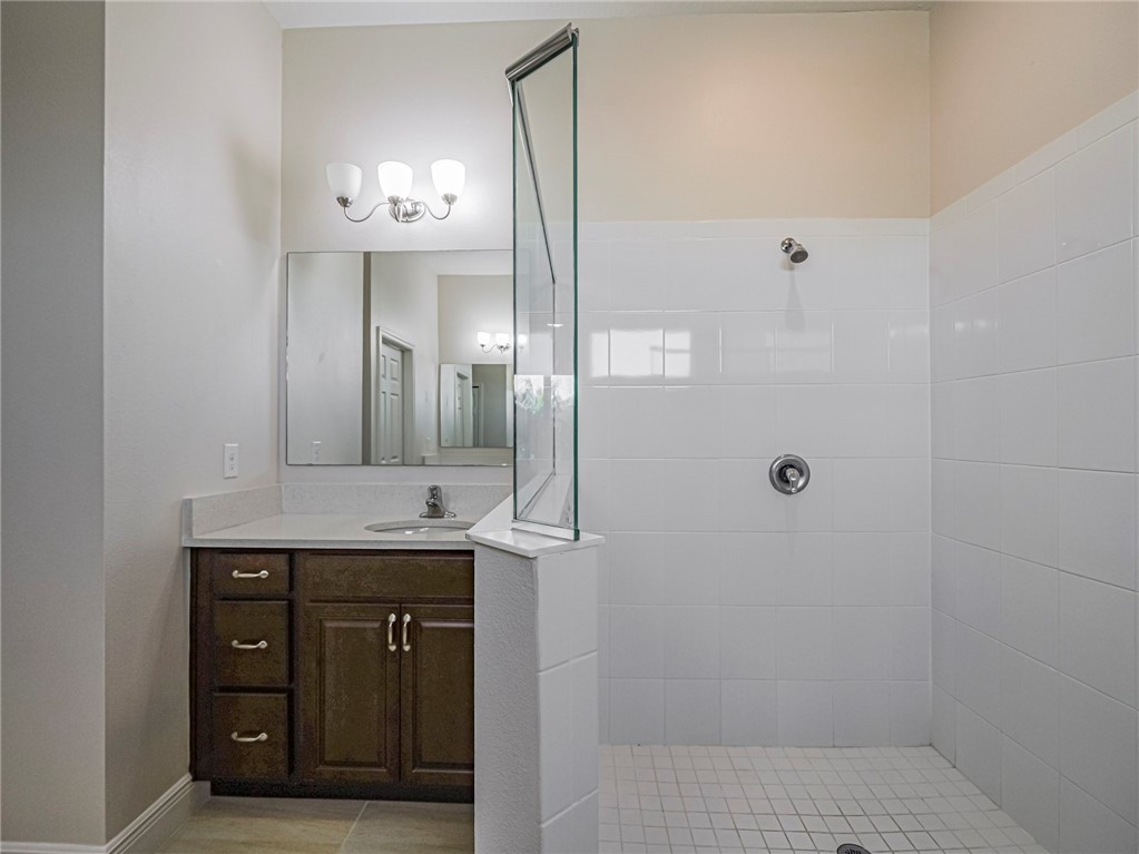 Bathroom featuring walk in shower and vanity