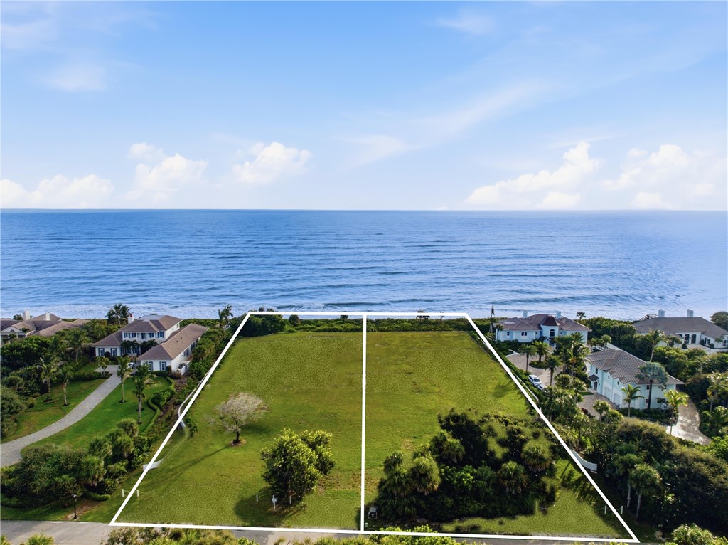 Oceanfront lot featuring direct coastal access, established mature trees, and expansive cleared land