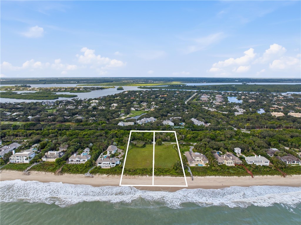 Direct oceanfront parcel featuring expansive beach access and mature coastal vegetation