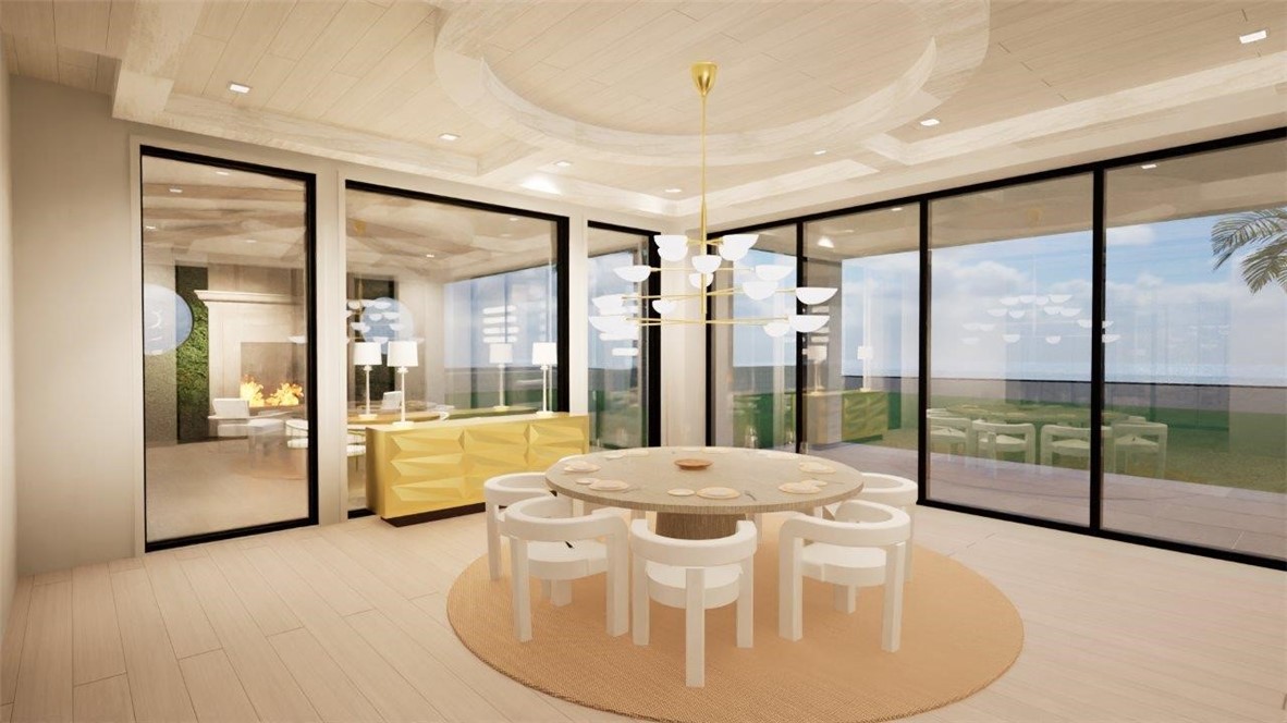 Tray ceiling with recessed lighting, multi-tiered brass chandelier, expansive floor-to-ceiling glass panel walls, and wood-finish flooring