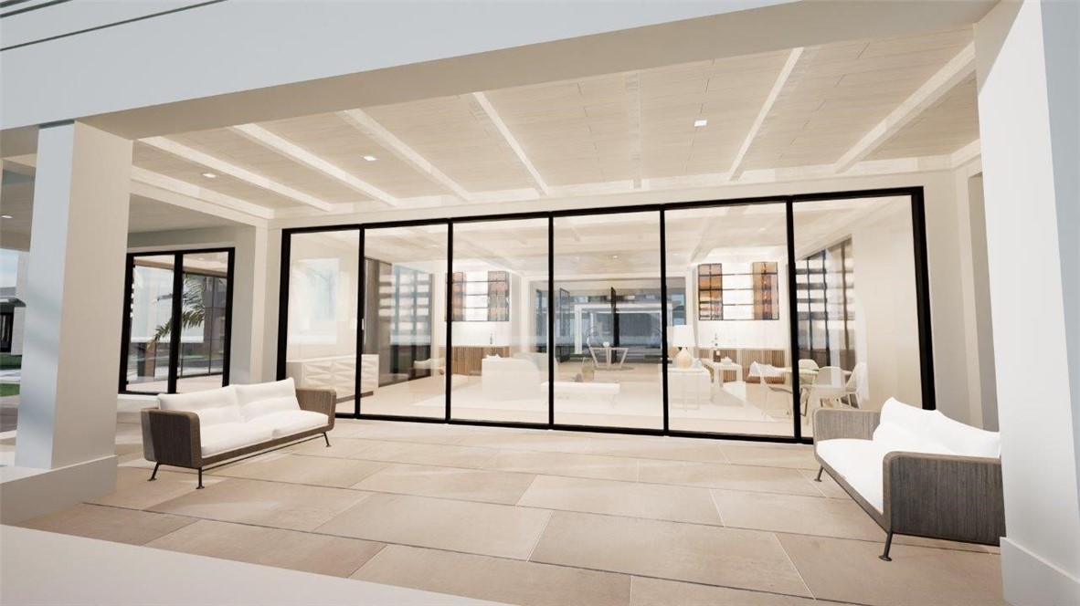 Covered patio featuring large-format stone tile flooring, a coffered ceiling with recessed lighting, and a multi-panel sliding glass door system