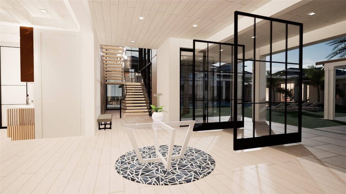 Open-concept interior featuring light wood-finish flooring, recessed lighting, a floating staircase with glass panel railing, and expansive floor-to-ceiling metal-framed glass doors
