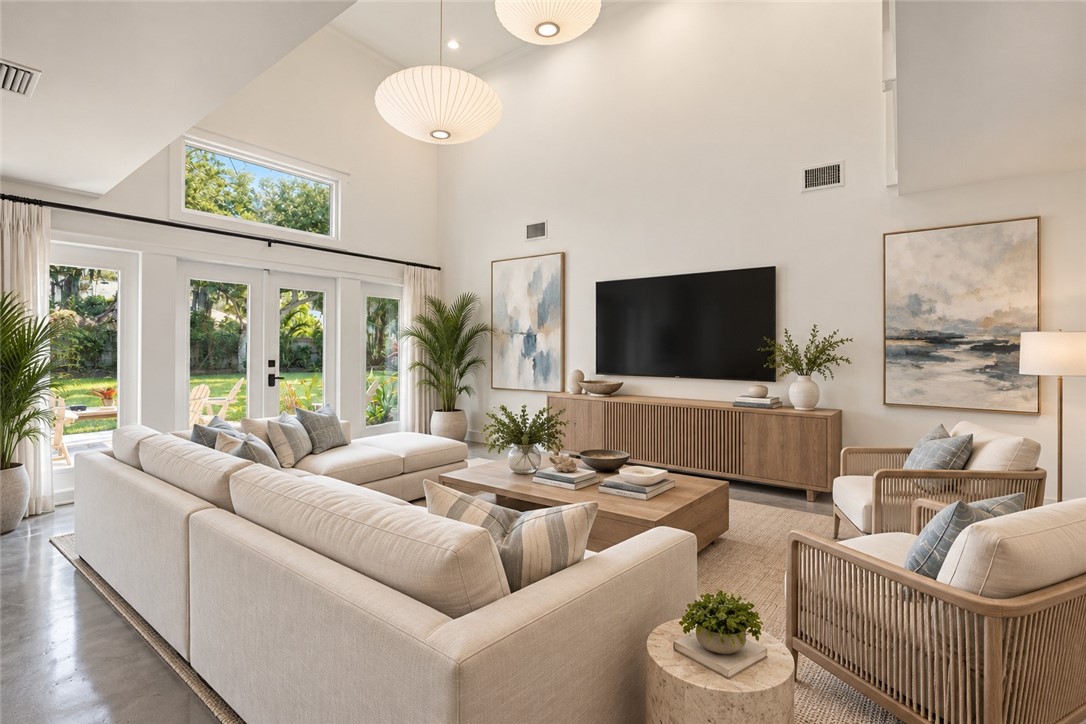 Virtually Staged - Vaulted ceilings, expansive windows, multiple glass-paned doors, and polished concrete flooring