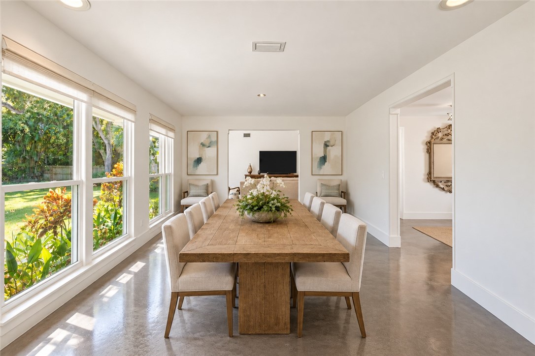 Virtually Staged - Polished concrete flooring, recessed lighting, and large picture windows featuring natural exterior scenery