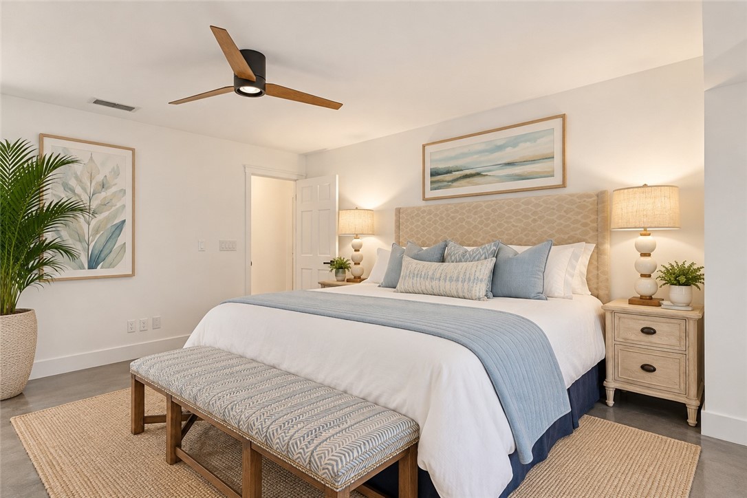 Virtually Staged - Interior space featuring smooth-finish ceiling, three-blade matte black ceiling fan with integrated lighting, and polished concrete flooring