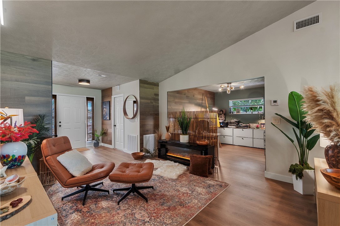 Vaulted ceilings, wood-finish flooring, and natural wood wall cladding