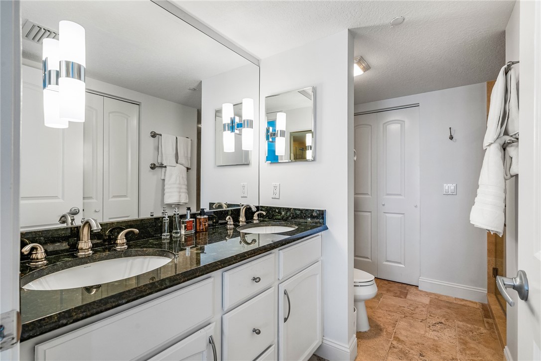 Master Bathroom has a glass door walk in shower and designer lighting over the sinks.