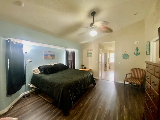 Vaulted ceilings, wood-finish flooring, and a ceiling fan with integrated lighting fixture
