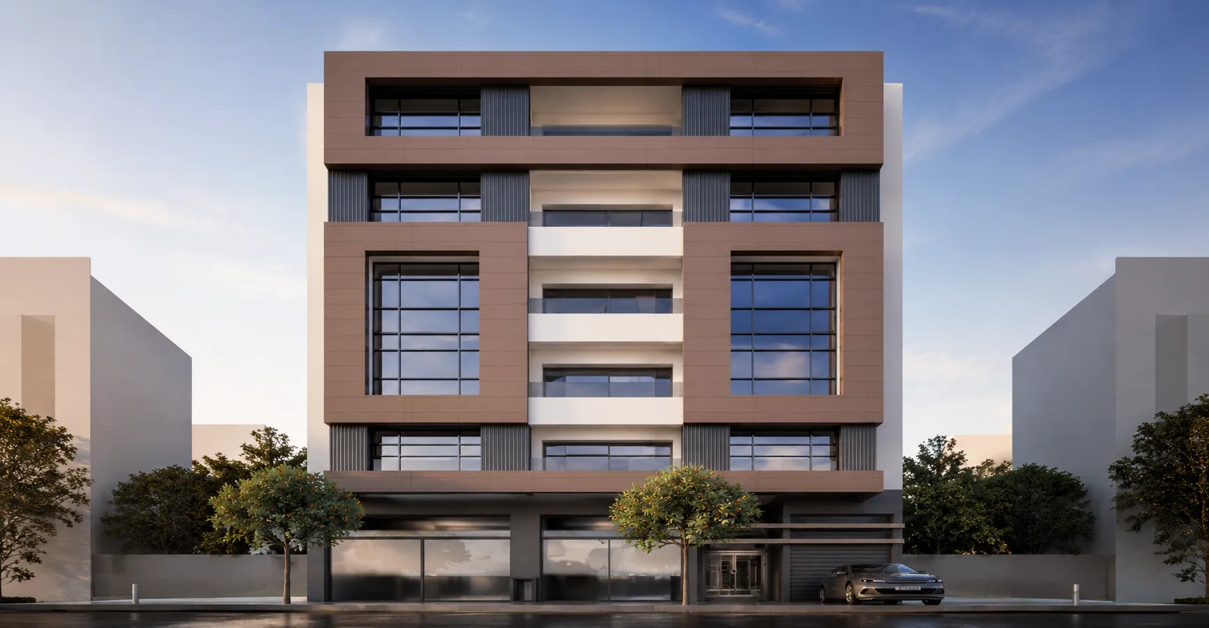 Modern four-story building with large rectangular windows framed in brown and white, featuring balconies in the center and a sleek gray car parked on the right under a clear blue sky.