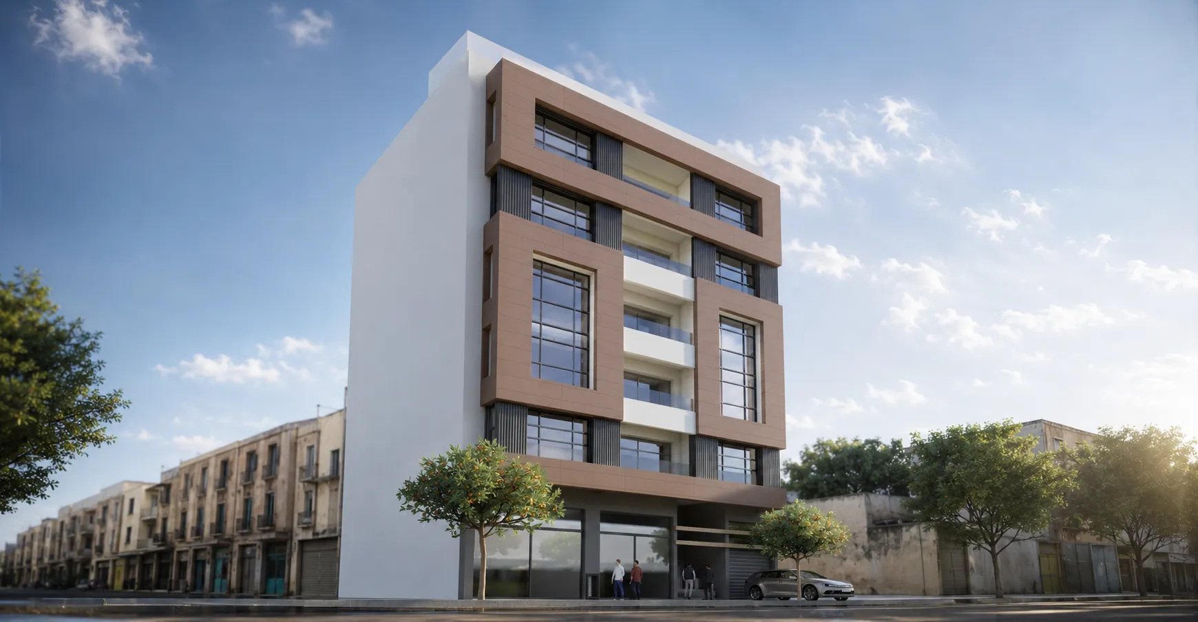 Modern four-story building with large rectangular windows and brown decorative frames, featuring glass balconies on the middle floors, situated on a street with older buildings and trees under a partly cloudy blue sky.