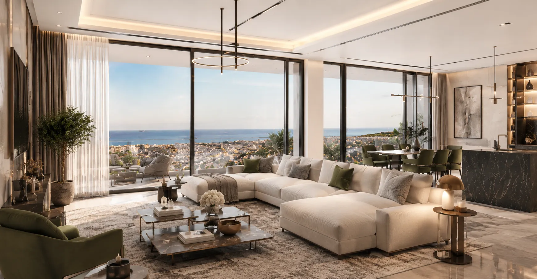 Modern open living room with a large beige sectional sofa adorned with green and gray pillows, two nested marble coffee tables with decorative items, and a green armchair, featuring floor-to-ceiling windows with a panoramic view of a coastal city and the ocean, plus a dining area with green chairs and contemporary pendant lighting.