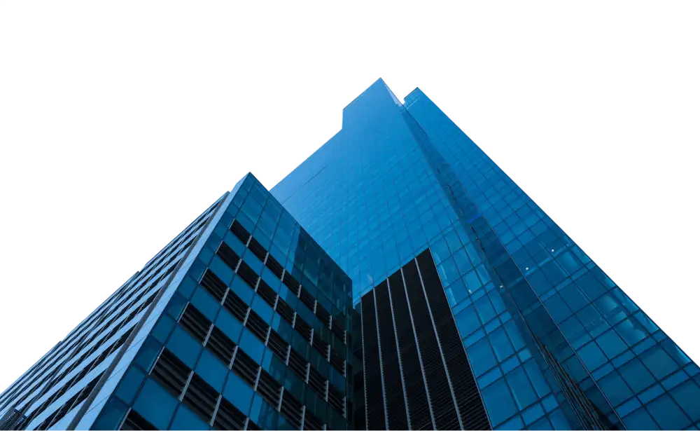 Upward view of a tall modern glass skyscraper with reflective blue windows and geometric patterns.