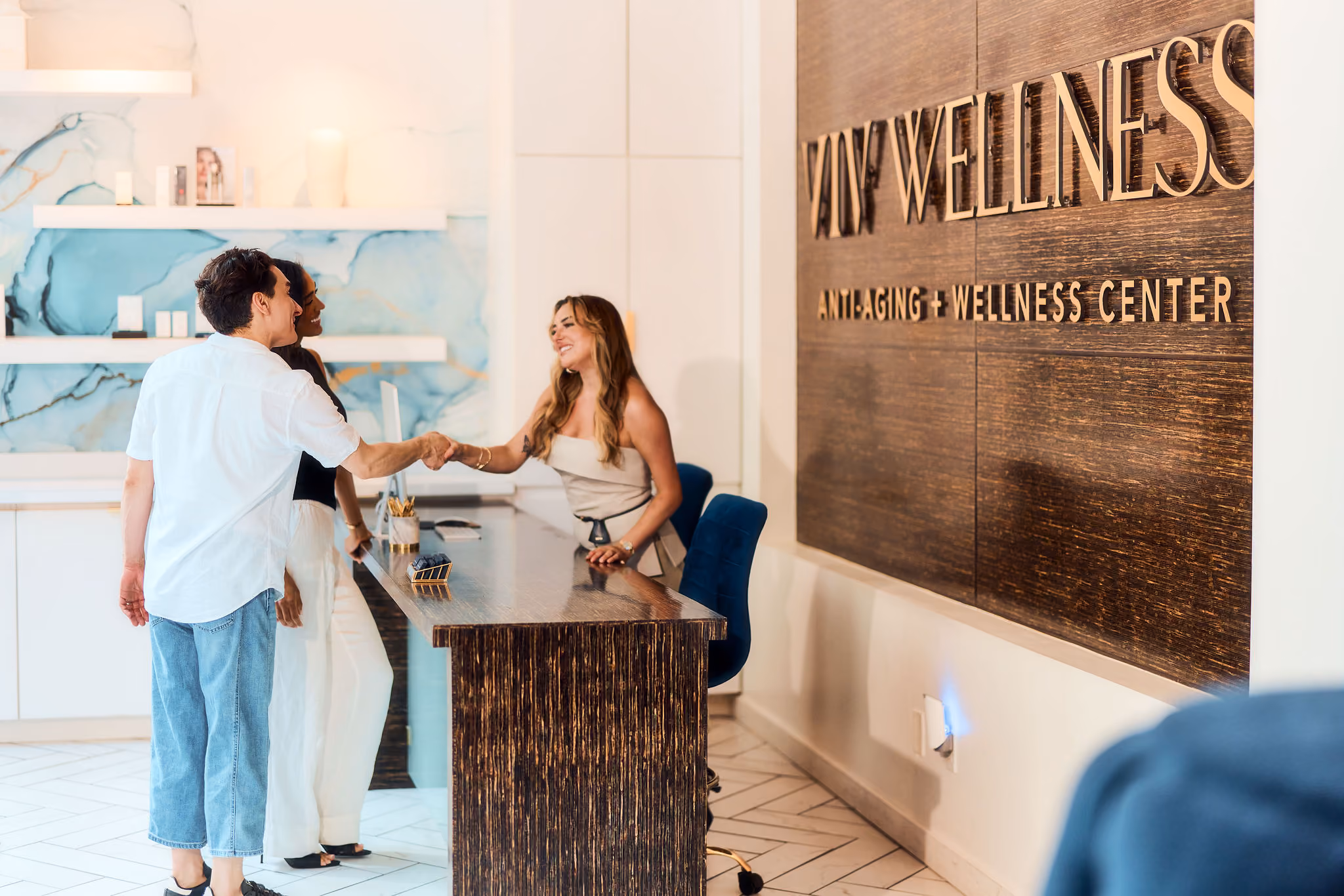 Reception and VIV Wellness sign inside the Victory Park clinic in Dallas