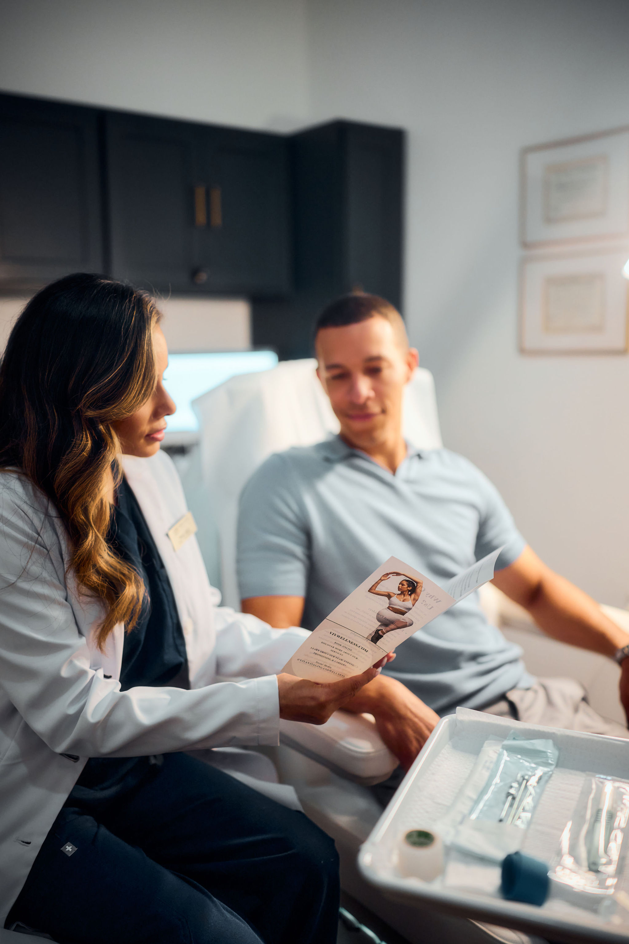 Physician reviewing lab results with a patient at VIV Wellness in Dallas
