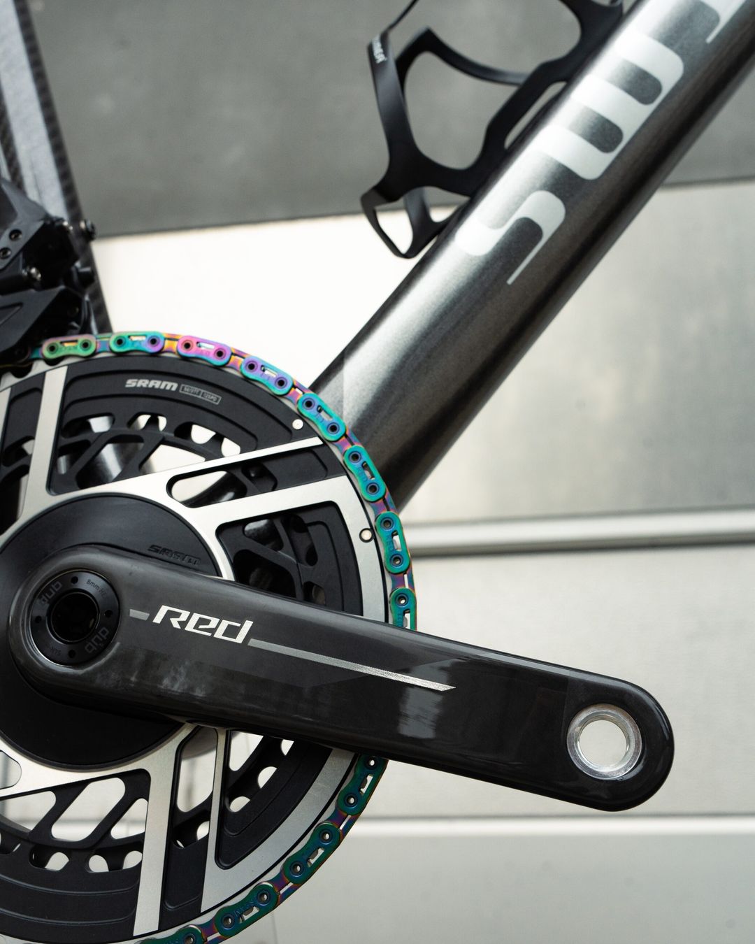 SRAM RED crank and power meter with an oil-slick chain, against the Aequus down tube