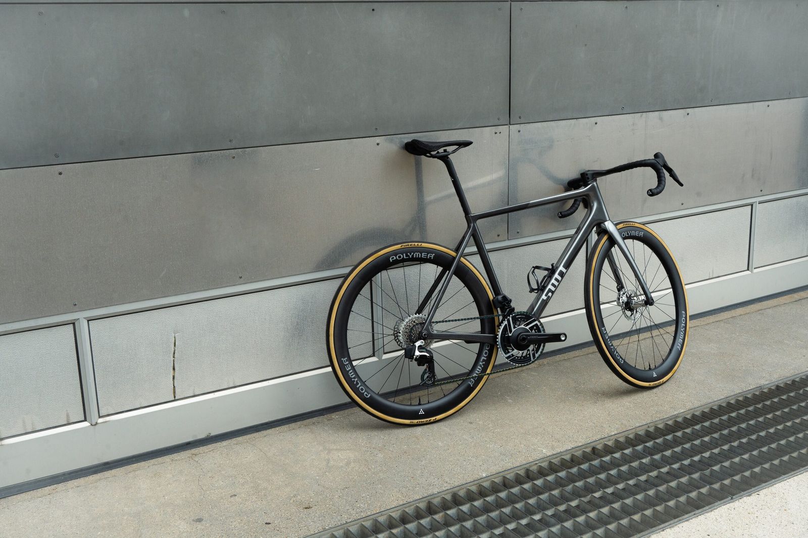 The Aequus shot wide against a full-height concrete wall