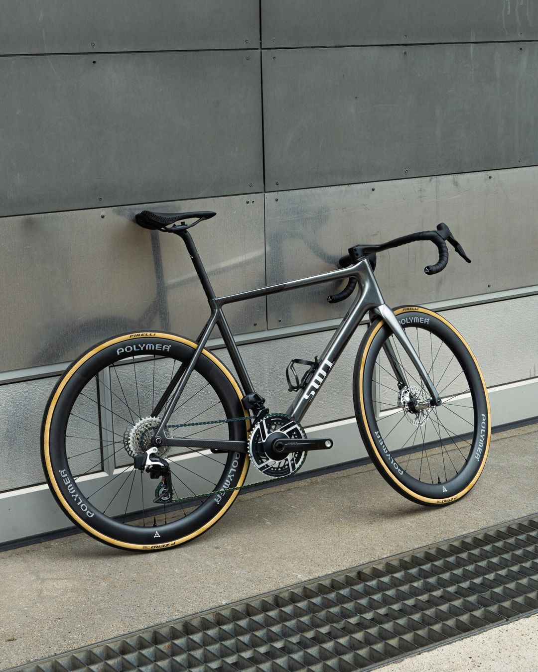 The SWI Aequus in three-quarter view against a concrete wall, on Polymer Workshop deep-section wheels