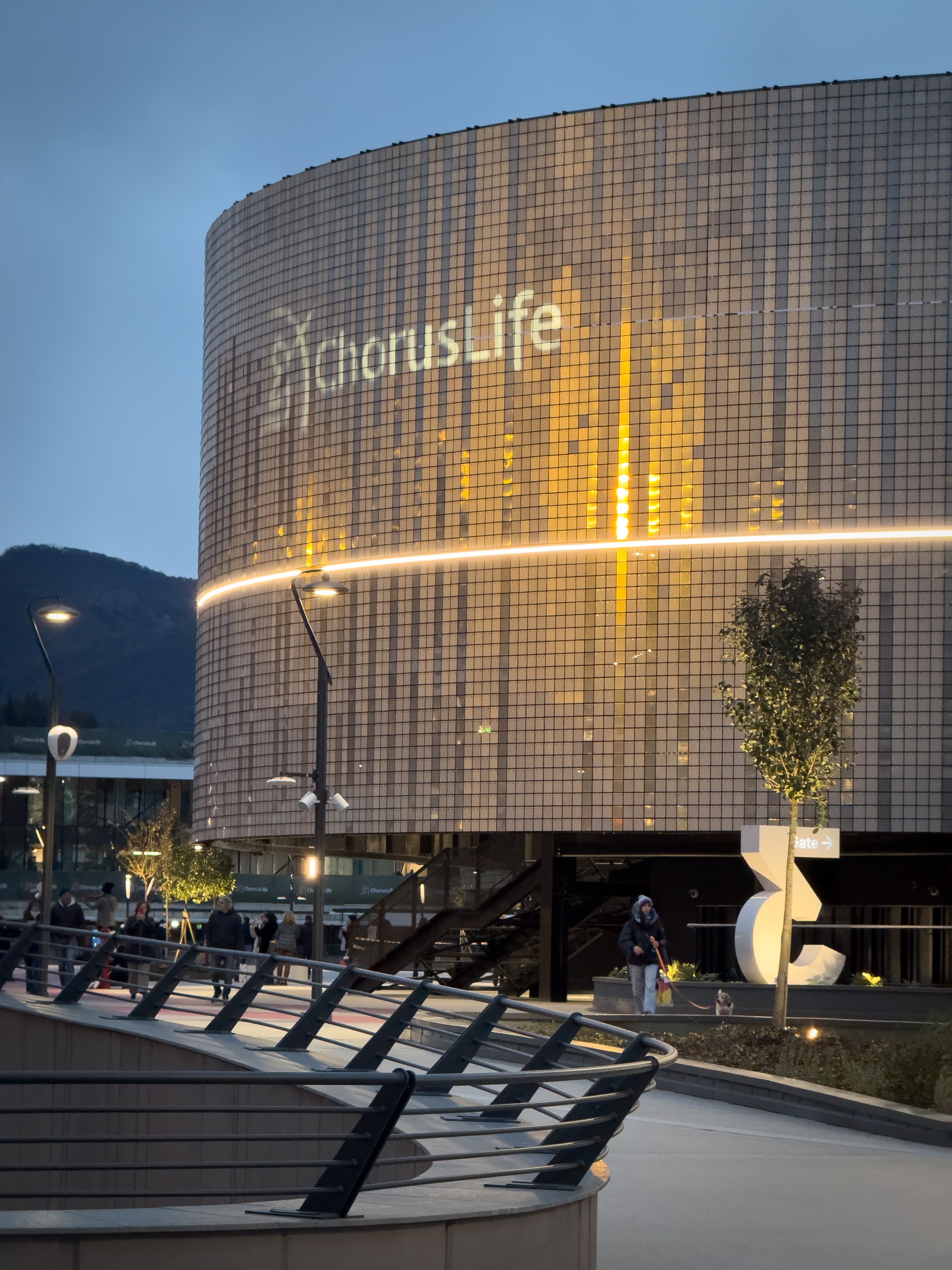 The hotel's glazed volume above the green terraces