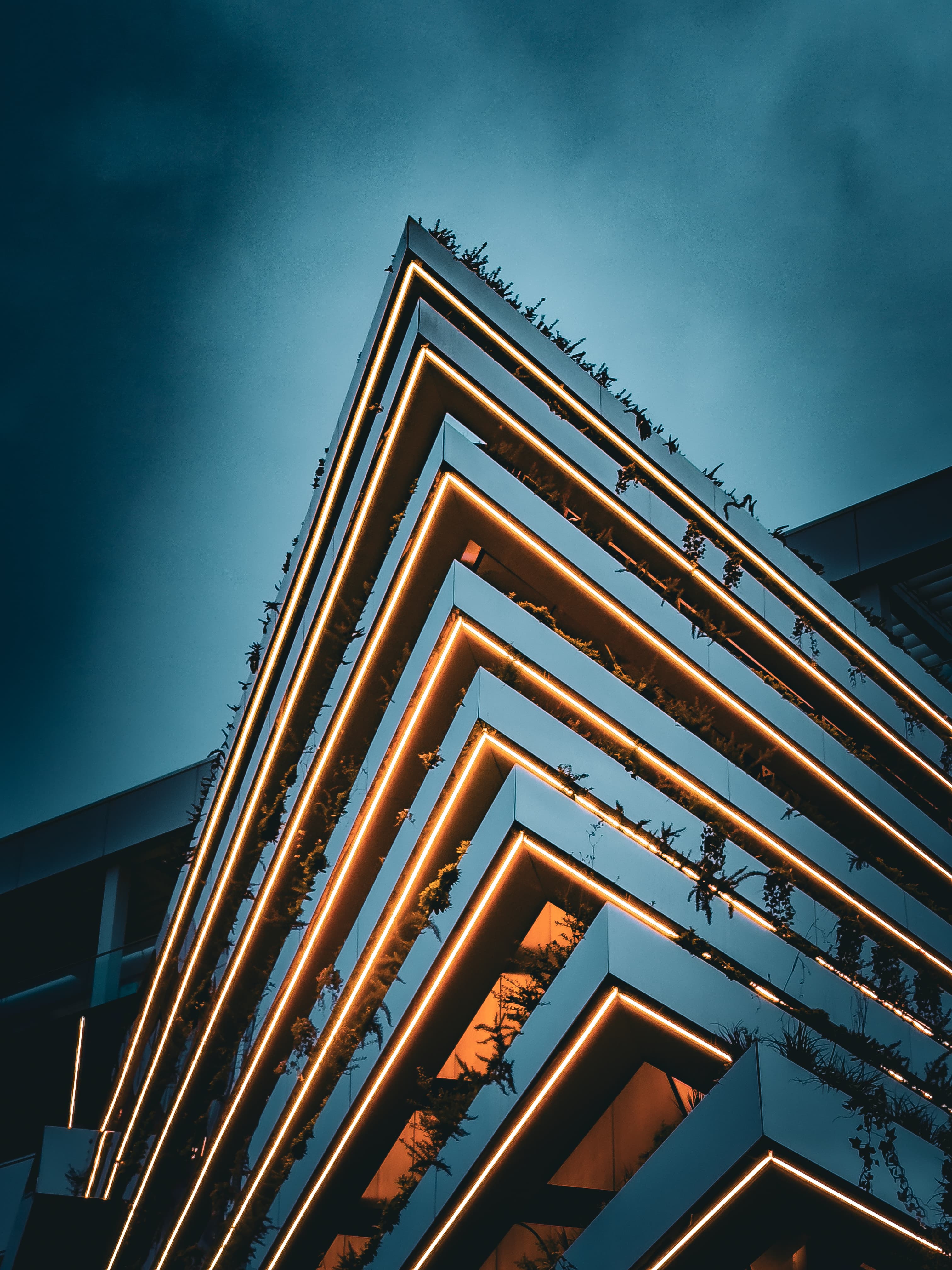 The hotel's glazed volume above the green terraces