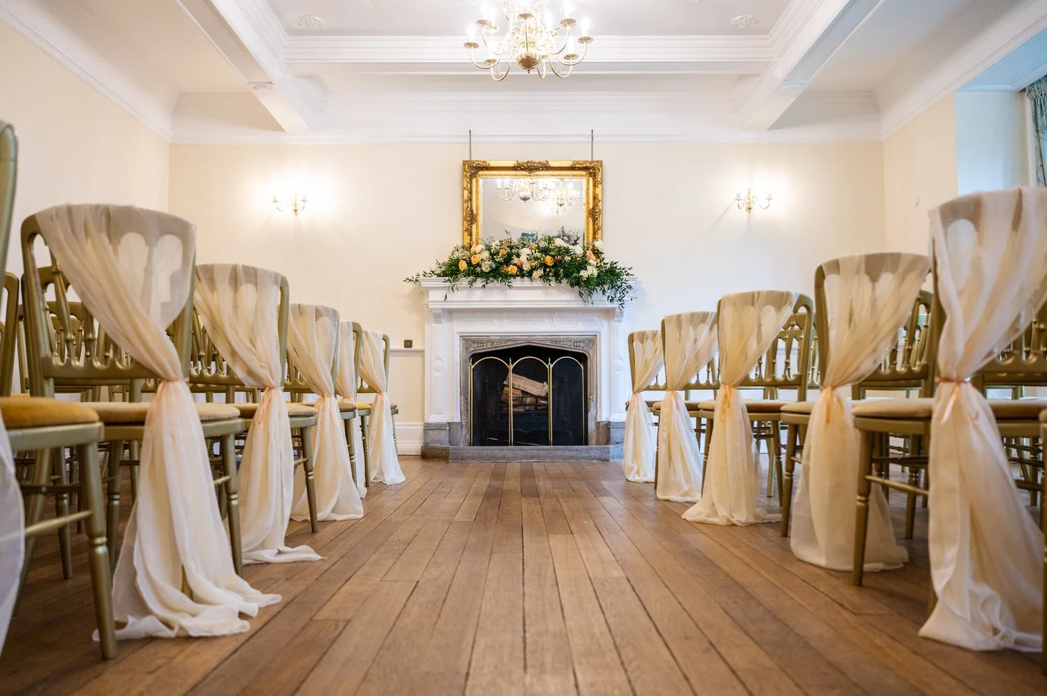 Elegant indoor wedding ceremony setup at Lanwades Hall